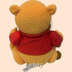 Disney Store a rejoint Winnie l'ourson en peluche de 12 pouces portant un t-shirt rouge.